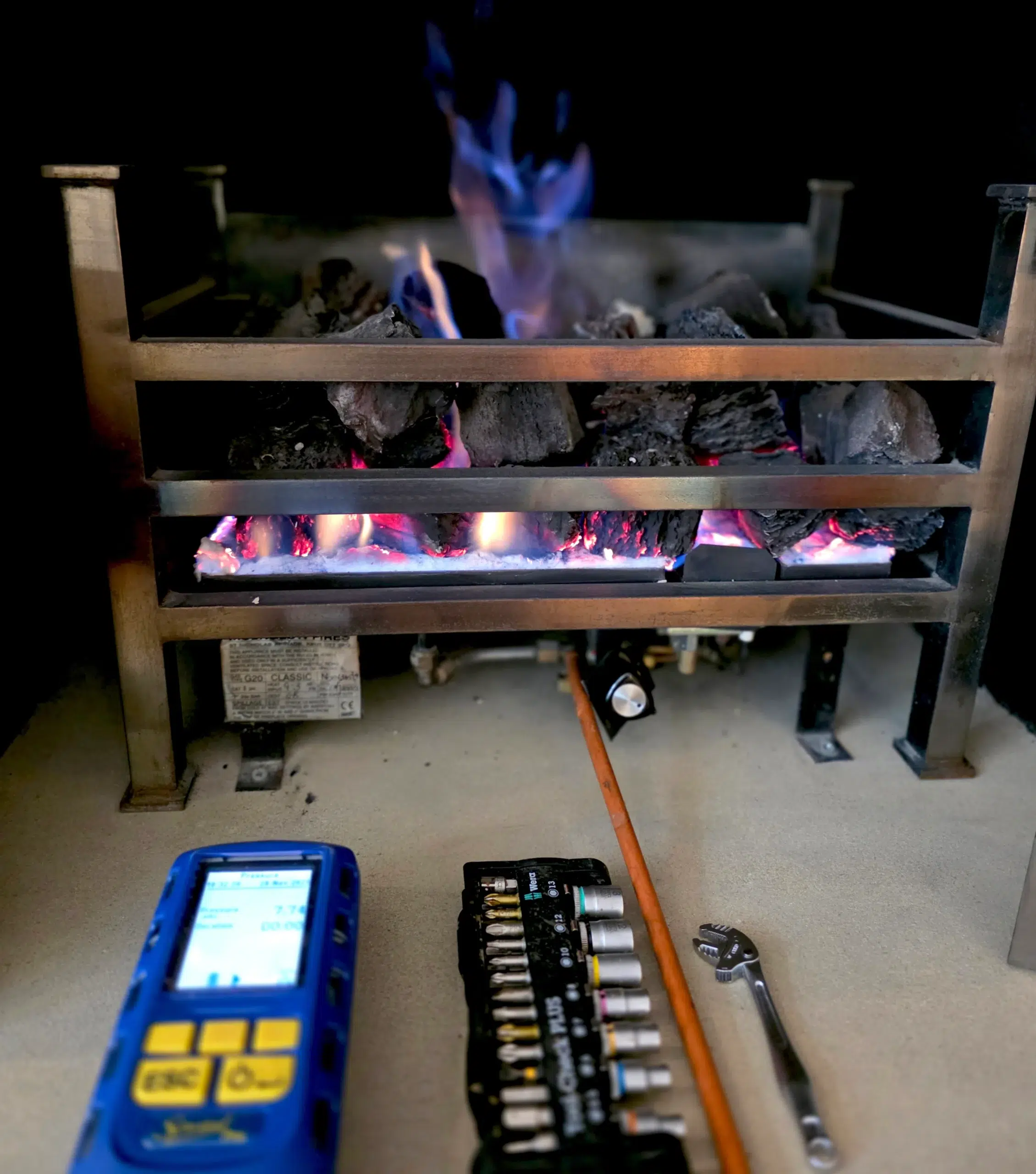 Gas engineer inspecting gas fire during home buyers survey in Streatham